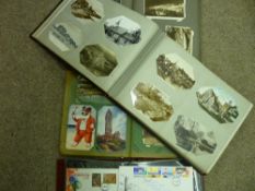 Collection of vintage postcards contained in three albums and a sleeved collection of first day