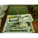 Cased quantity of collector's teaspoons and three plastic trays of EP and other cutlery