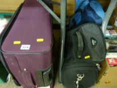 Modern wheeled suitcase and two canvas holdalls