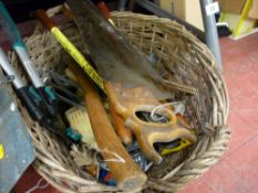 Two handled wicker basket containing garden tools and a quantity of long handled garden tools