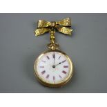 A FIFTEEN CARAT GOLD CASED LADY'S FOB WATCH with ribbon bow pin, gilt highlighted white enamel dial,