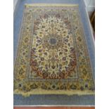 AN ISFAHAN WOOL RUG, with three row border and a fawn ground centre with blue and red floral and