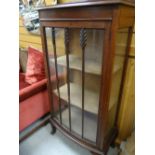 A neat vintage bow fronted glass display cabinet