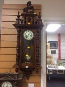 A vintage mahogany veneered Roman numeral faced Vienna wall clock