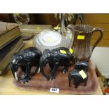 Four carved wooden elephant figures, lustre jug, Dartington 'Sunflower' glass plate etc