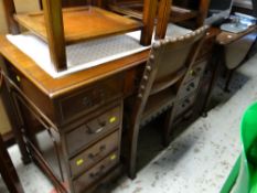 A nice compact reproduction mahogany kneehole desk with green leather tooled top together with a