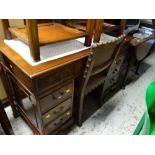 A nice compact reproduction mahogany kneehole desk with green leather tooled top together with a