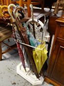 A painted white cast iron stick / umbrella stand & contents of umbrellas