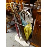 A painted white cast iron stick / umbrella stand & contents of umbrellas