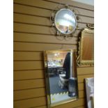 A modern brass effect wall mirror together with a vintage circular wall mirror