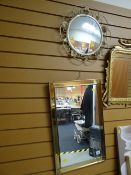 A modern brass effect wall mirror together with a vintage circular wall mirror