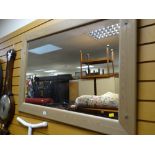 A modern pine framed mirror together with a vintage oval mahogany bevelled wall mirror