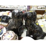 A pair of black & gilt decorated Staffordshire dogs
