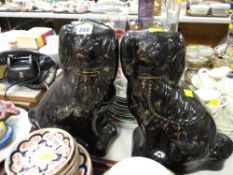 A pair of black & gilt decorated Staffordshire dogs