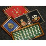 Collection of cased insignia, helmet badge, embroidered badges relating to the Welsh Regiment