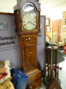 An antique flame mahogany eight day longcase clock with painted face by Hall & Co, Cardiff