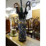 A continental ceramic stick / umbrella stand & contents including shooting stick, walking sticks