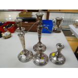 Candelabra, pair of small candlesticks together with another candlestick, white metal believed to be