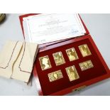 A boxed set of gold plated solid silver Empire Collection issue stamps