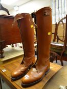 A pair of tan leather riding boots