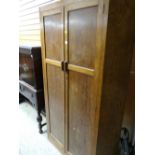 A vintage light oak shaped front two-door wardrobe