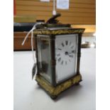 Brass mantel clock with Roman numeral face