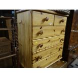 A modern honey pine small chest of drawers, two short above four long