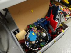 Crate of various children's plastic racing track & vehicles together with a tin of marbles