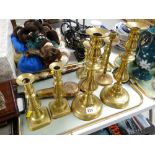 Four pairs of various brass candlesticks, copper & brass powder flask, Oriental dagger