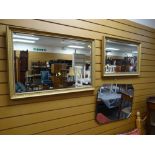 Two modern gilt framed bevelled wall mirrors together with another