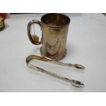 A hallmarked silver engraved tankard together with a pair of hallmarked silver sugar tongs