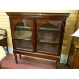A GOOD VICTORIAN MAHOGANY SLIDING DOOR BOOKCASE on stand with inverted step cornice, twin glazed