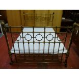 A 4ft 6ins VICTORIAN BRASS BED FRAME with connecting irons and spring base, 112 cms high, 141 cms