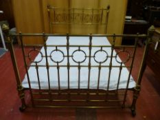 A 4ft 6ins VICTORIAN BRASS BED FRAME with connecting irons and spring base, 112 cms high, 141 cms