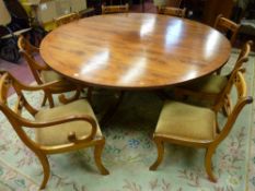 A REGENCY STYLE WALNUT CIRCULAR DINING TABLE and eight (six plus two) dining chairs, the 180 cms