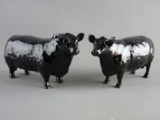 A BESWICK POTTERY ABERDEEN ANGUS BULL & COW, 1562 and 1563, 20 cms long the largest