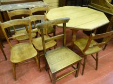 AN EDWARDIAN OAK OCTAGONAL TOPPED TABLE and six vintage farmhouse chairs (five and one), 75.5 cms