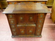 A GOOD WALNUT CASED SINGER SEWING MACHINE TABLE, the lift-up lid with pop-out treadle sewing