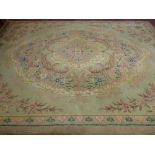 A VINTAGE TUFTED WOOLLEN CARPET having a central floral cartouche and spandrel corners with a single