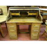 AN EARLY TO MID 20th CENTURY OAK ROLL TOP DESK, typical form with interior top arrangement of