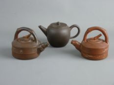 THREE CHINESE YIXING TERRACOTTA STYLE TEAPOTS to include an undecorated globular example with