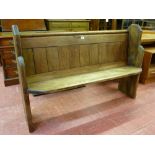 A VINTAGE PINE CHURCH PEW with shaped ends, 92 cms high, 137 cms wide, 42 cms deep overall