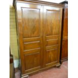 A VICTORIAN MAHOGANY CHAMFERED PANEL FRONT TWO DOOR WARDROBE, the twin three panel doors opening