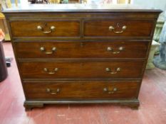 A LATE GEORGIAN MAHOGANY CHEST of two short over three long drawers, all oak lined with circular