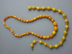TWO SETS OF AMBER COLOURED BEADS (untested), 85 grms gross, the largest bead 2 cms