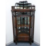 A HIGH VICTORIAN ROSEWOOD CORNER DISPLAY CABINET having a three tier mirrored structure with