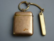 A NINE CARAT GOLD VESTA CASE, 20.6 grms on a keyring type fastener with small gold coloured