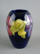 A MOORCROFT 'CLEMATIS' 13 cms HIGH VASE decorated on a cobalt blue ground, impressed factory marks