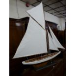A MODERN FULLY RIGGED MODEL DISPLAY YACHT on a rectangular ebonized stand, 152 cms high overall, 145