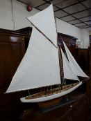 A MODERN FULLY RIGGED MODEL DISPLAY YACHT on a rectangular ebonized stand, 152 cms high overall, 145